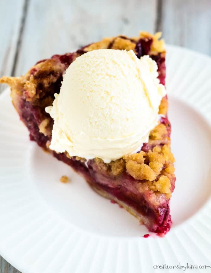 overhead shot of slice of pie on a plate with ice cream