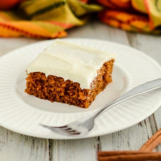 pumpkin bar with cream cheese frosting on a plate with a fork