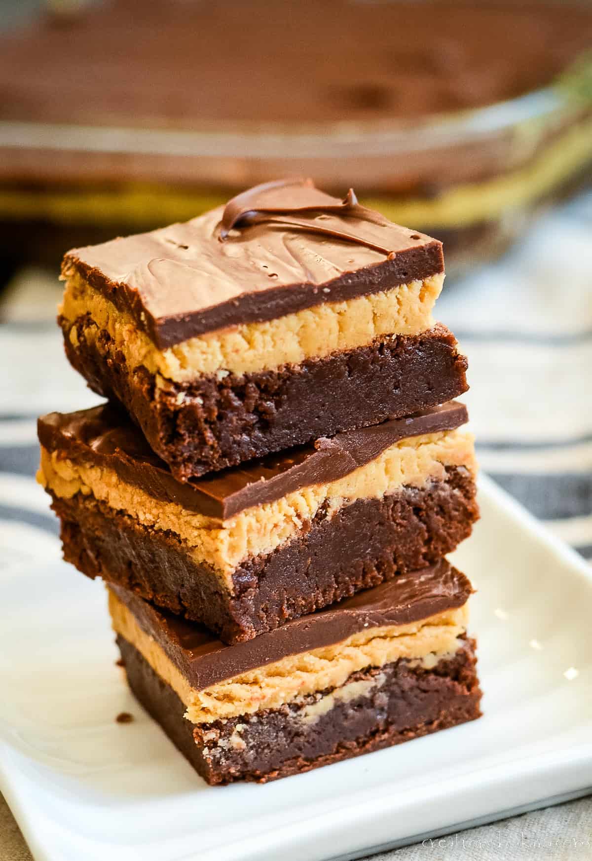 stack of buckeye brownies on a white plate