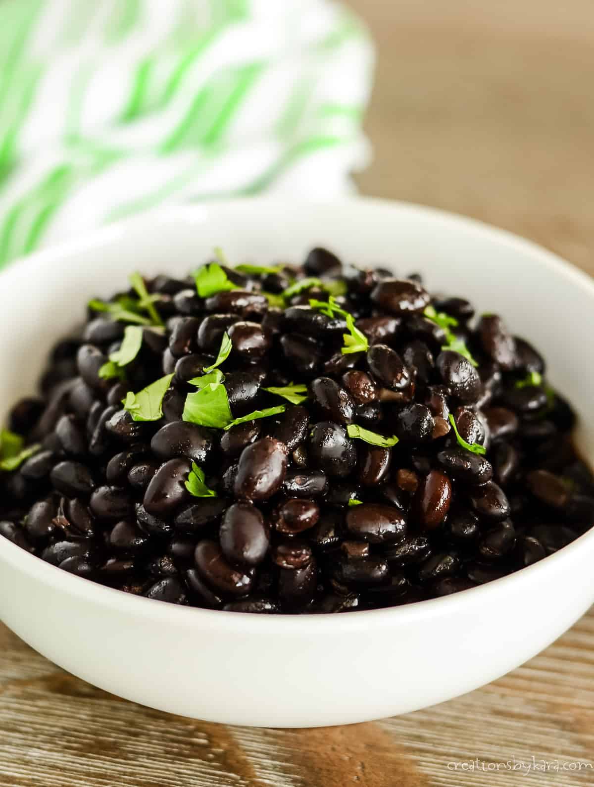 slow cooker mexican black beans garnished with cilantro