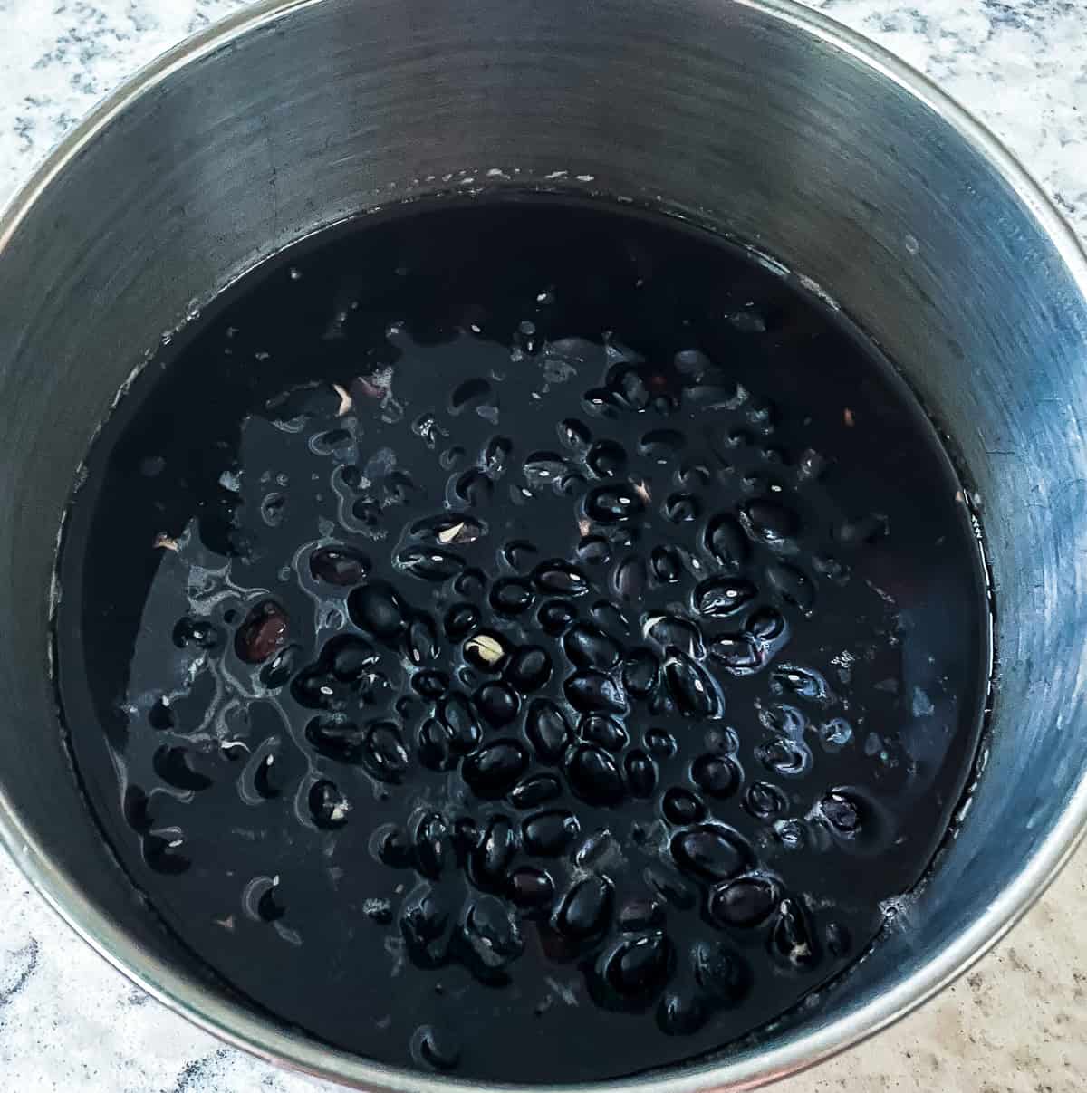 black beans soaking in a pot