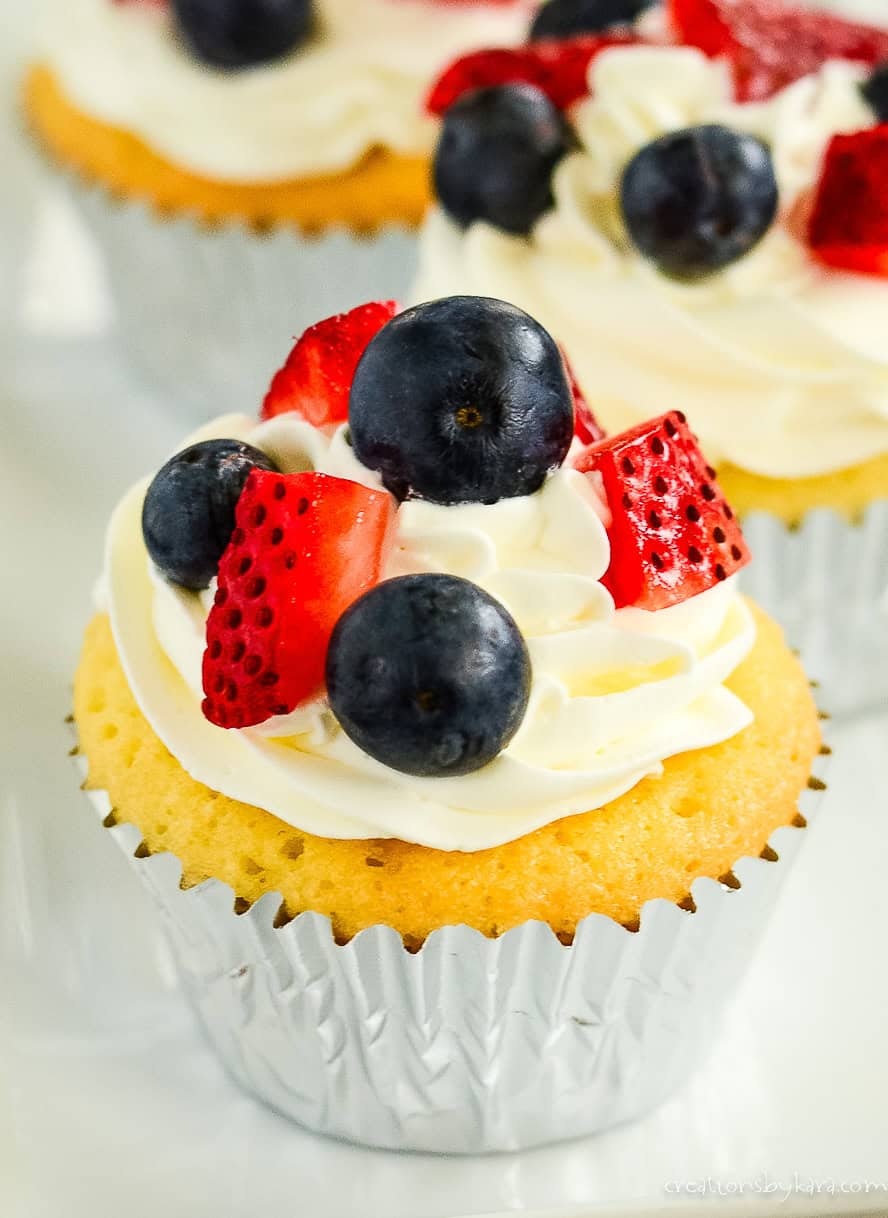 easy pound cake cupcake recipe topped with whipped cream and berries