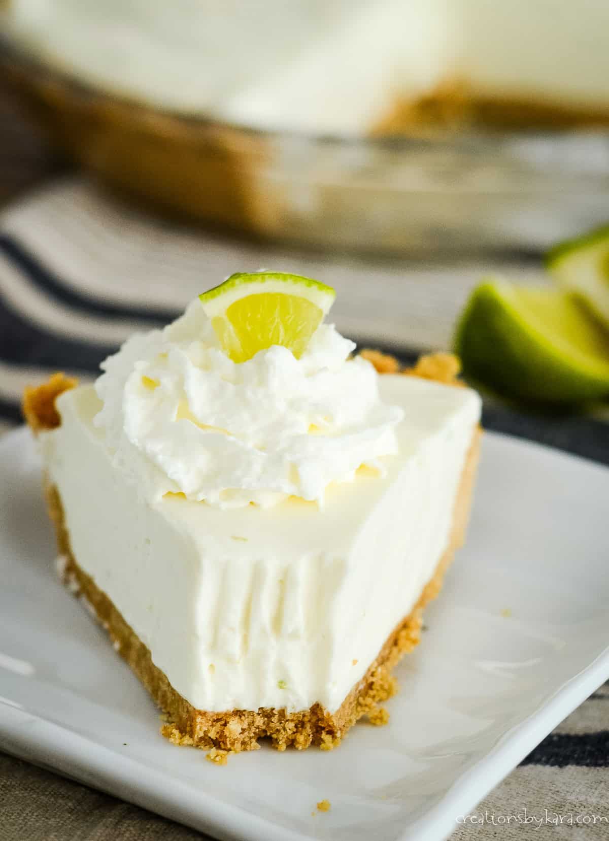 slice of no bake key lime pie with a bite taken out of it