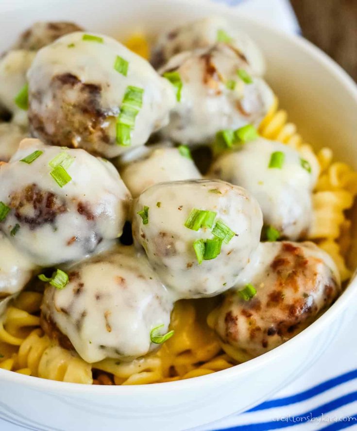 bowl of meatballs in cream sauce over pasta