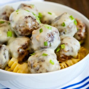 meatballs in cream sauce garnished with green onions