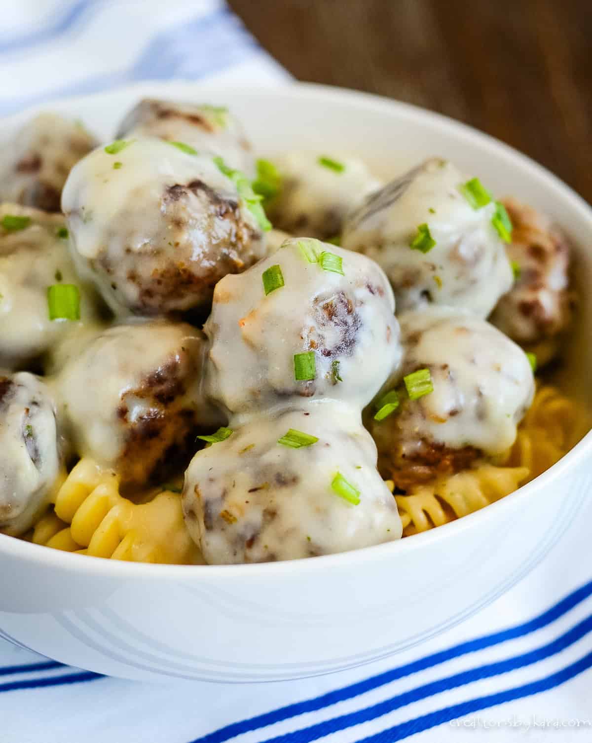 meatballs in cream sauce garnished with green onions