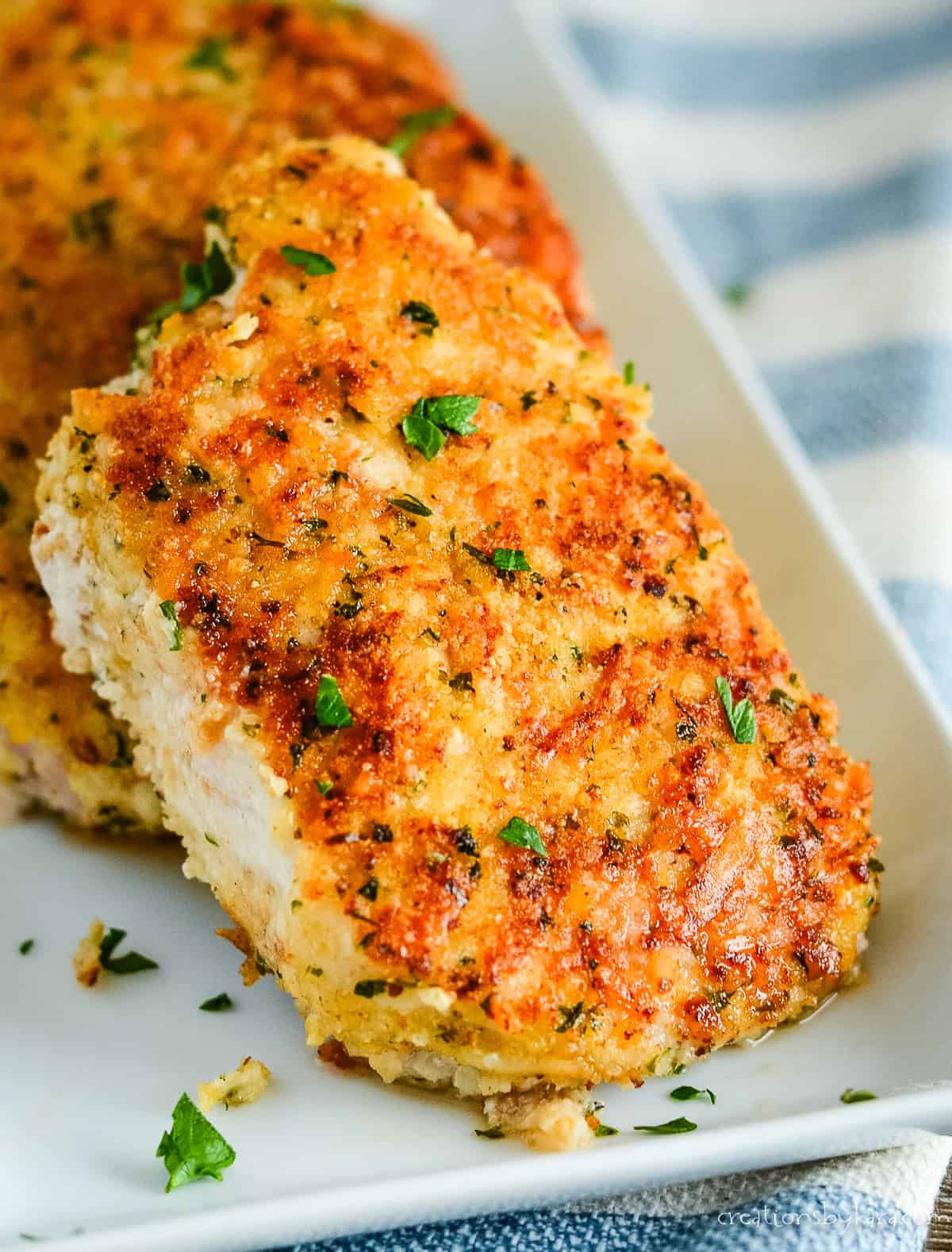 parmesan pork chops on a white tray