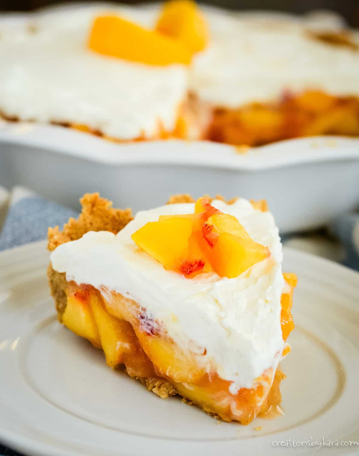 slice of creamy peach pie with graham cracker crust