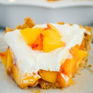 slice of creamy peach pie with graham cracker crust