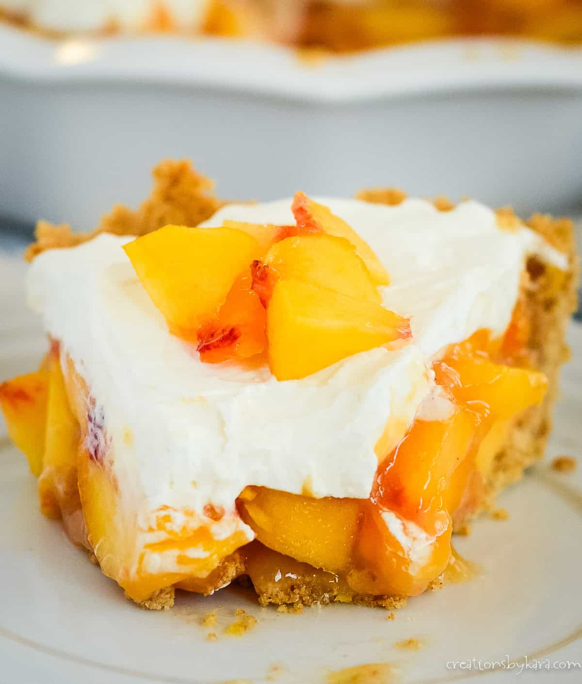 slice of creamy peach pie with graham cracker crust