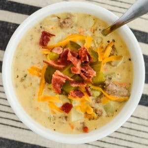 bowl of velveeta cheeseburger soup with a spoon in it