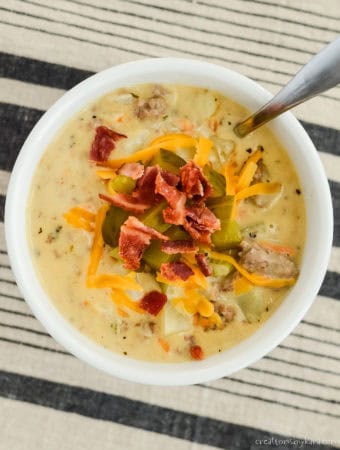 bowl of velveeta cheeseburger soup with a spoon in it