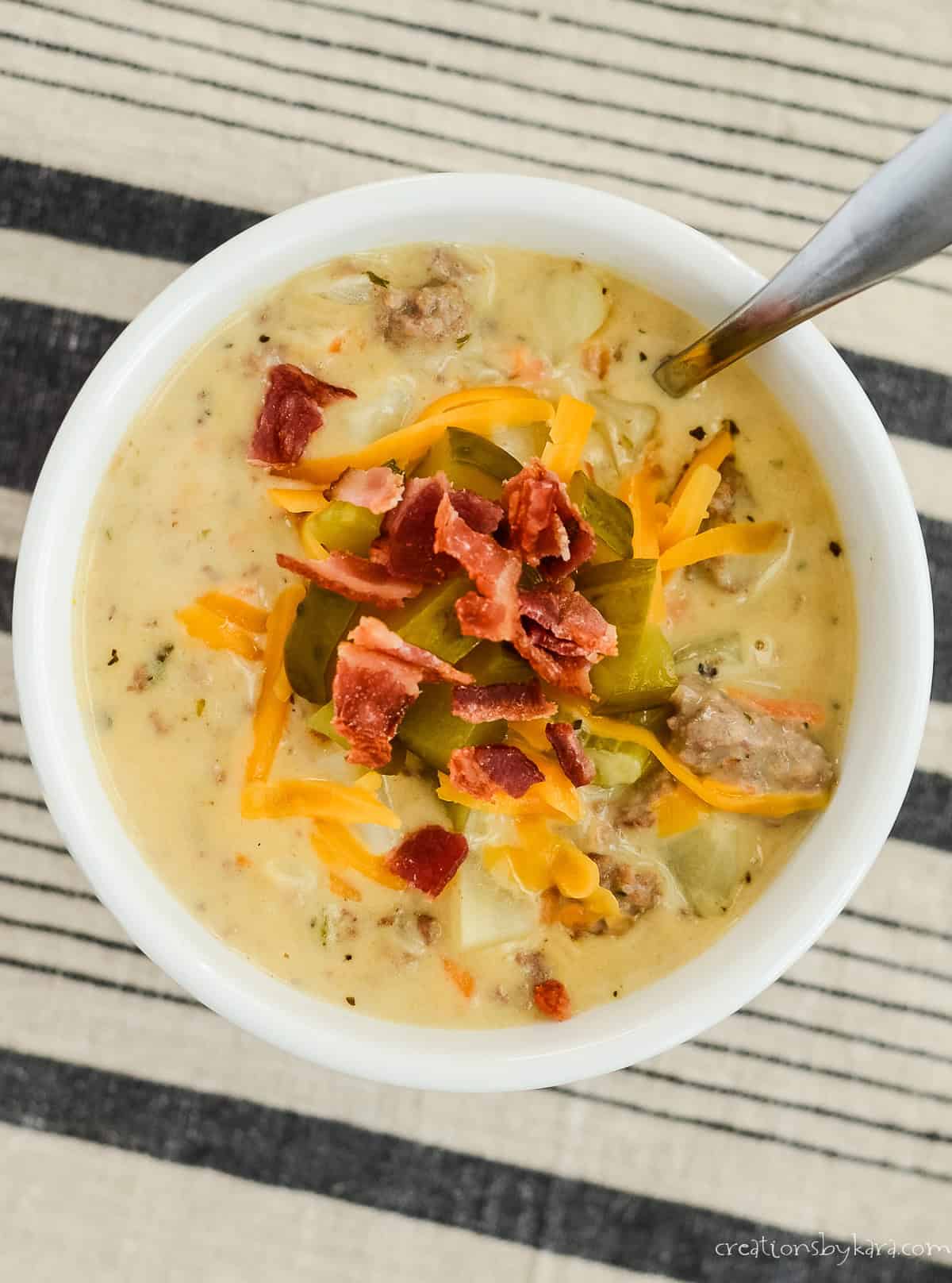 bowl of velveeta cheeseburger soup with a spoon in it