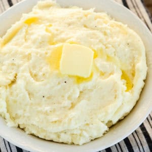 bowl of garlic mashed potatoes with a pat of butter