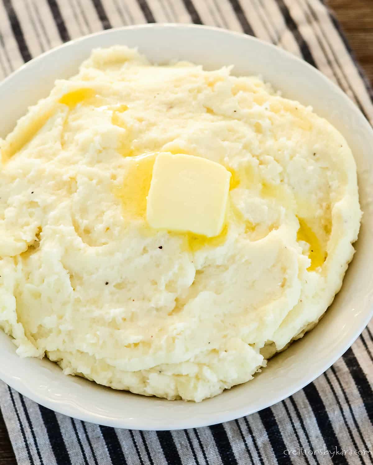 bowl of garlic mashed potatoes with a pat of butter