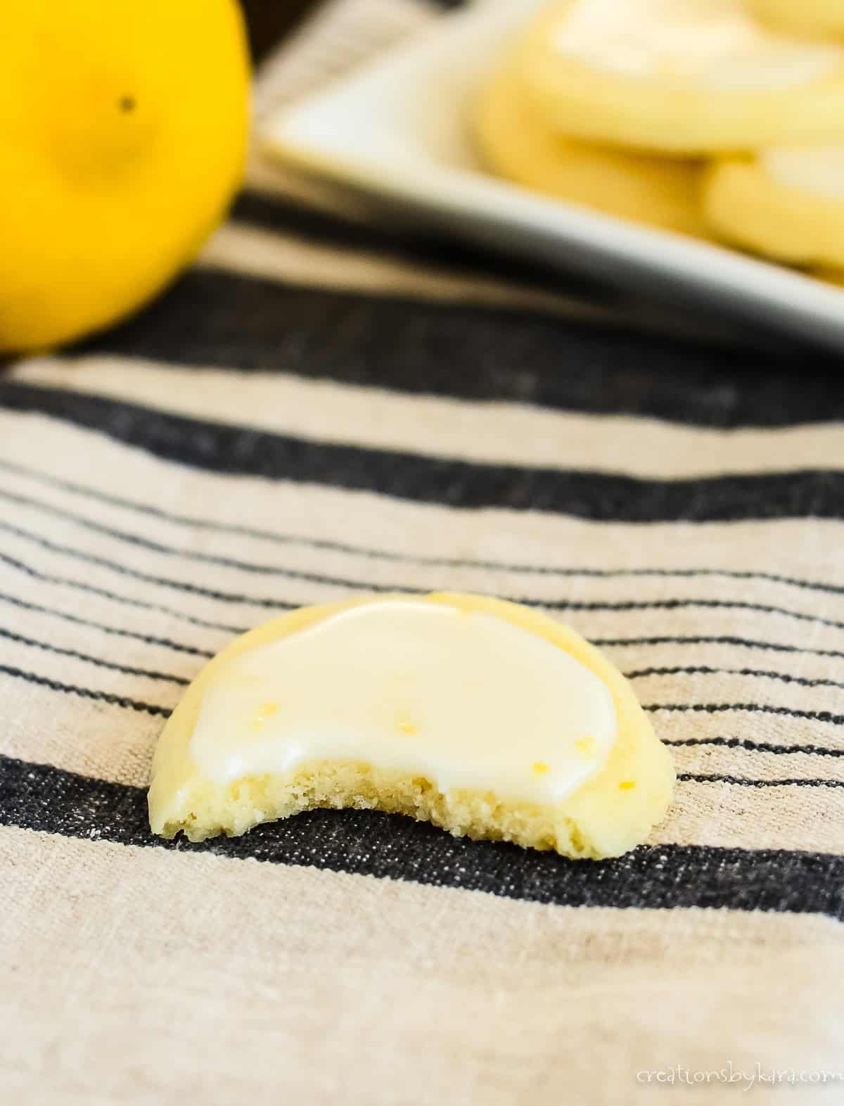 glazed italian lemon cookie with a bite taken out of it