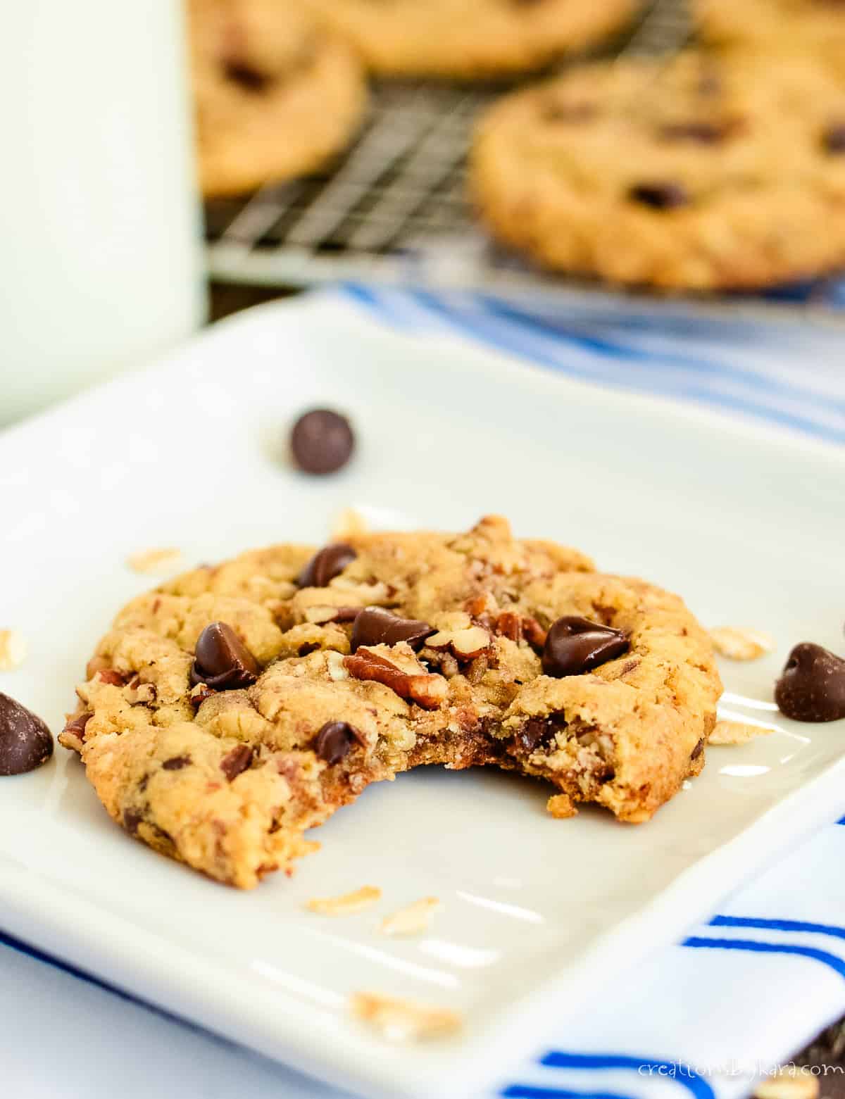 million dollar cookie with a glass of milk in the background