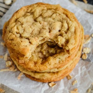 coconut oatmeal cookies, one with a bite taken out of it