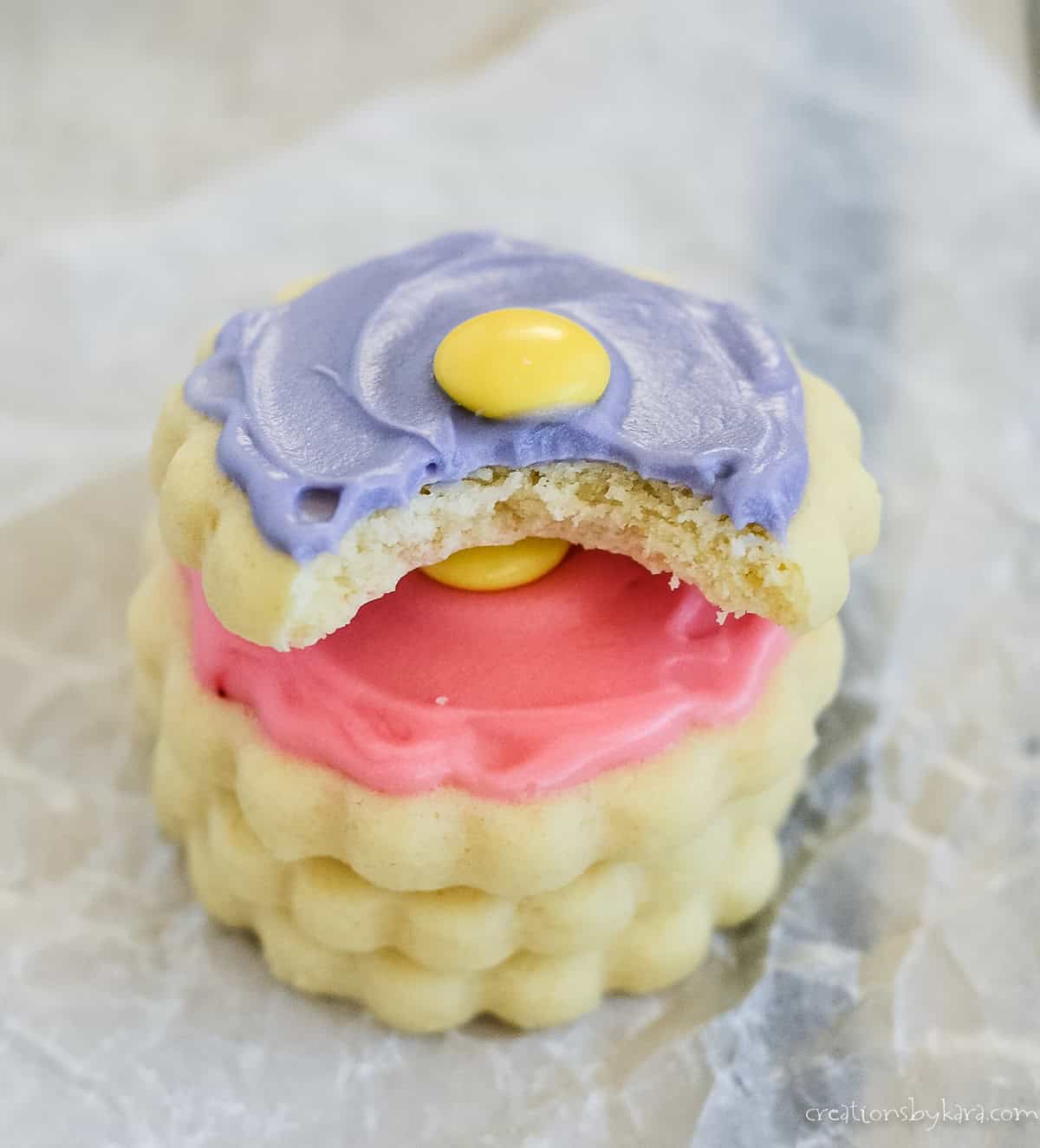 stack of cream cheese sugar cookies with buttercream frosting