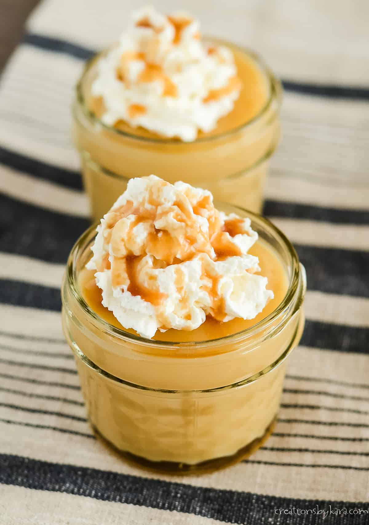 homemade butterscotch pudding topped with whipped cream and caramel sauce