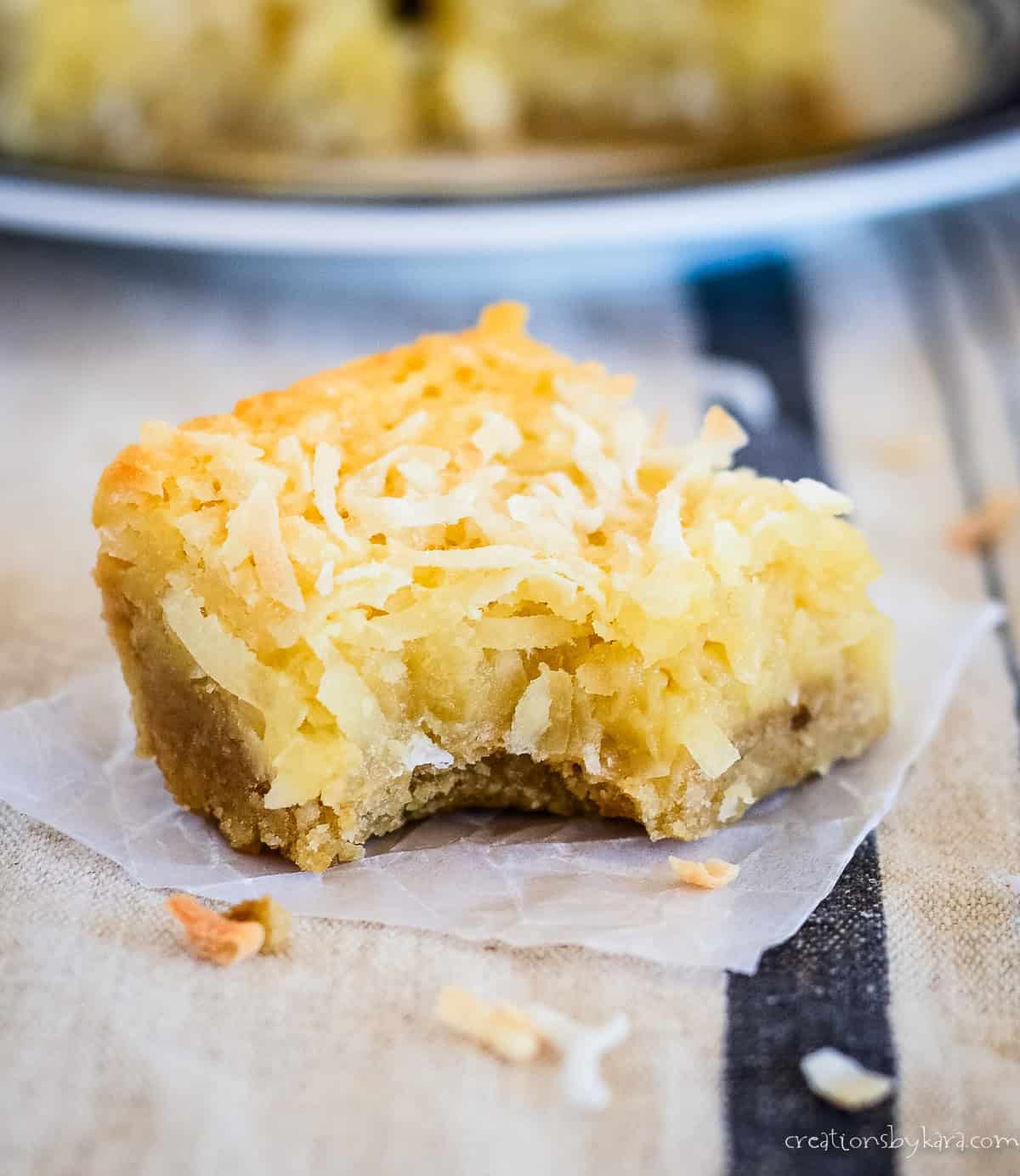 chewy coconut bar with a bite taken out of it