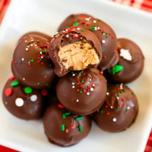 chocolate peanut butter balls with christmas sprinkles