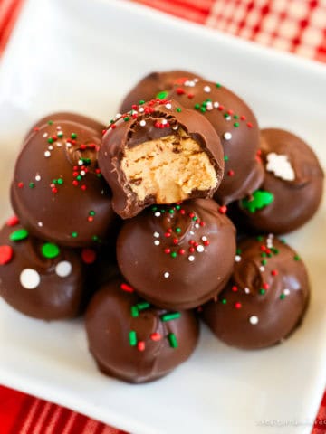 chocolate peanut butter balls with christmas sprinkles