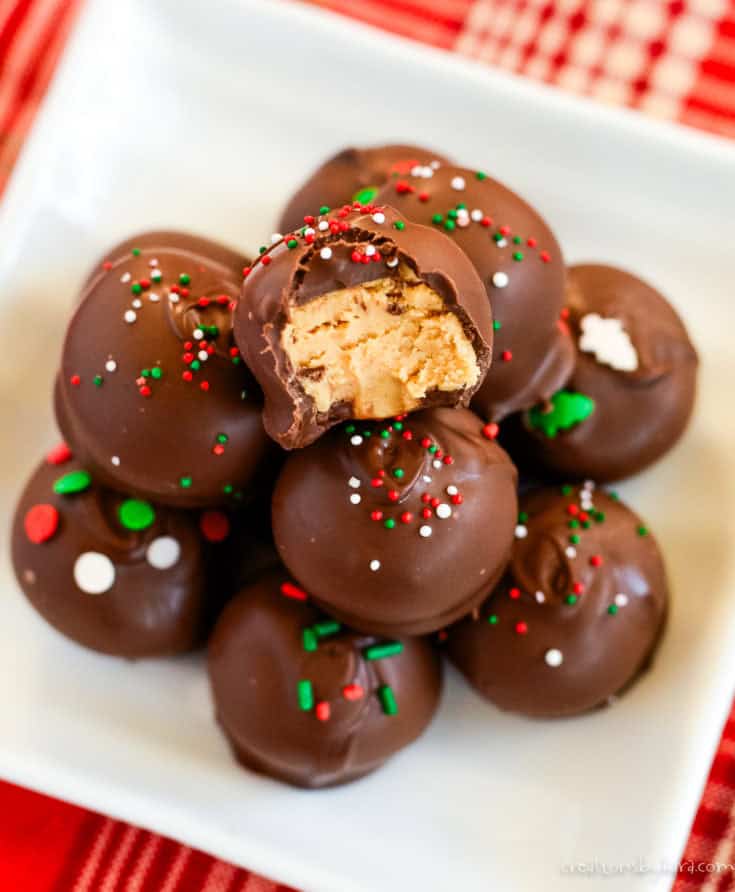 chocolate peanut butter balls with christmas sprinkles