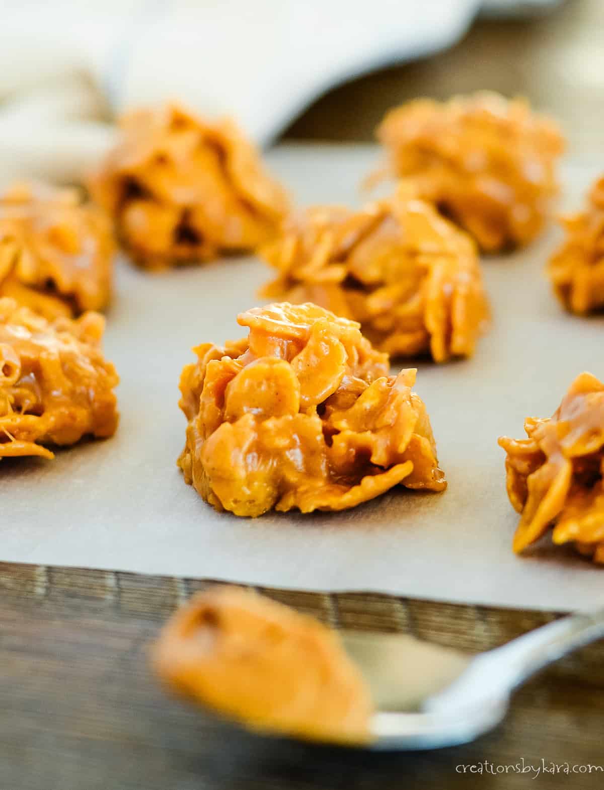 cornflake candy with a spoonful of peanut butter in the foreground