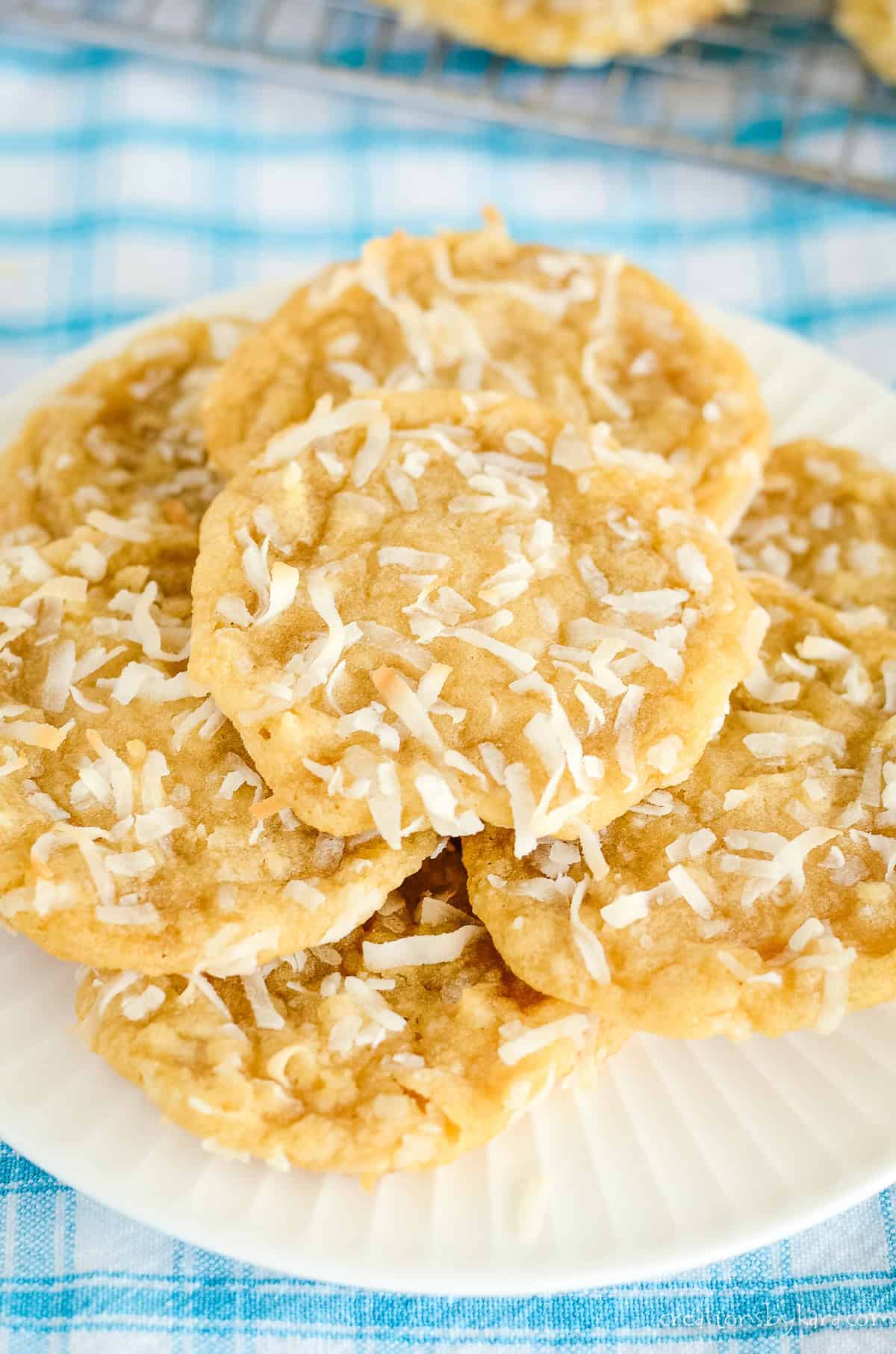 stack of chewy coconut cookies on a white plate