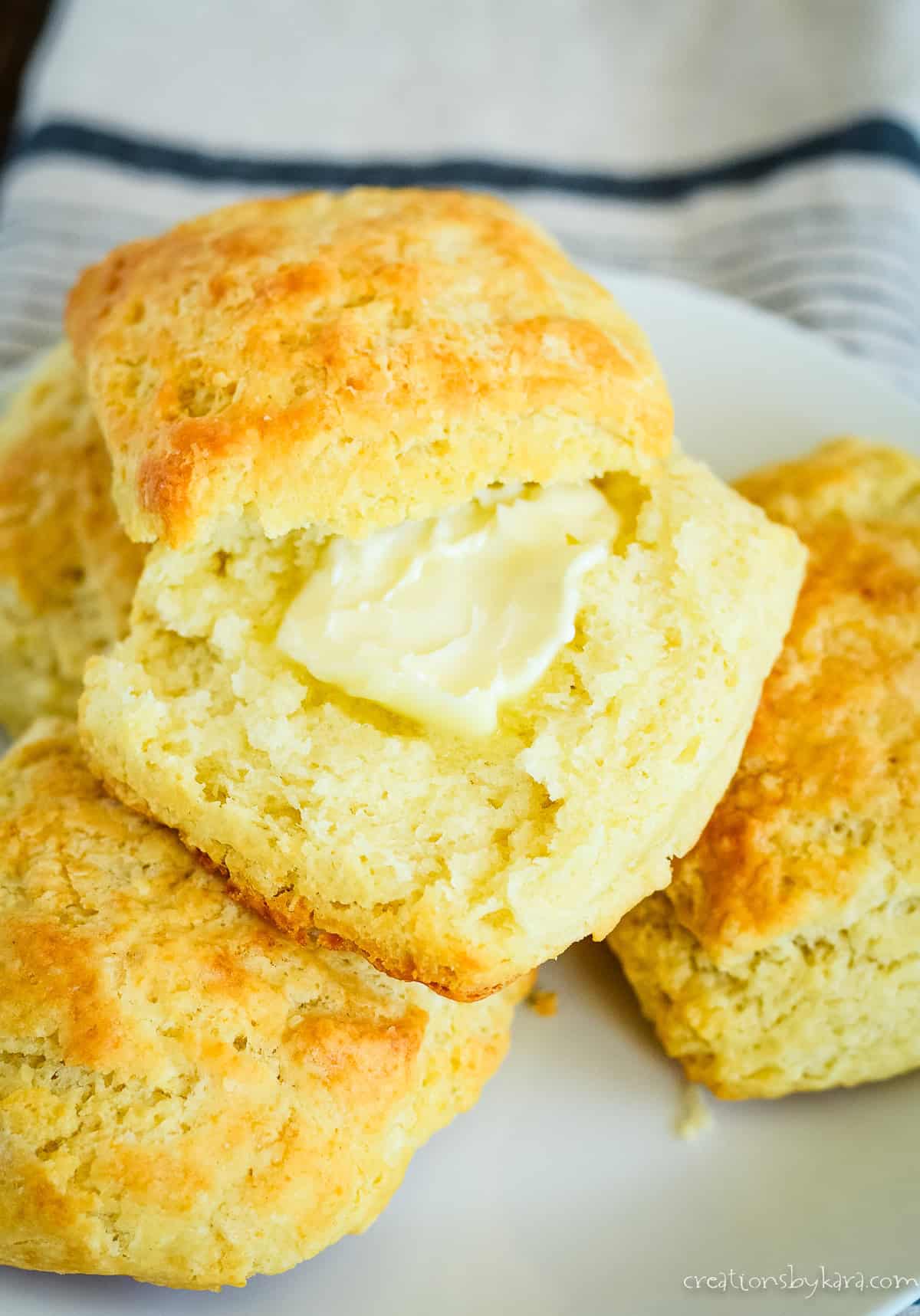 warm sourdough biscuit split with butter in the middle